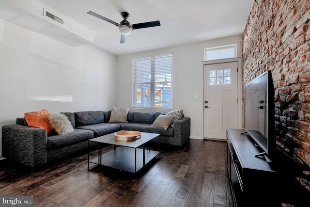 living room with dark wood finished floors, a ceiling fan, and visible vents