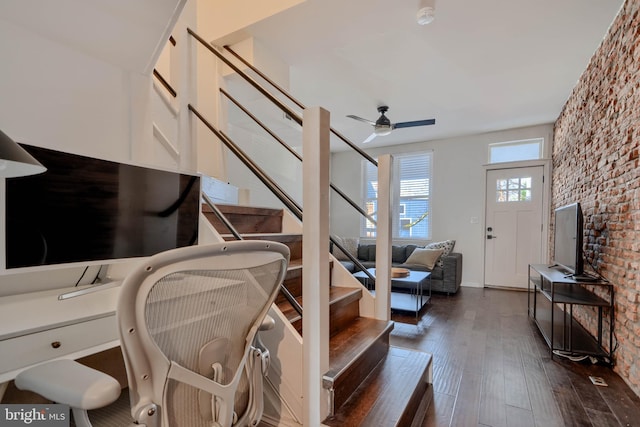 stairway with wood finished floors and a ceiling fan