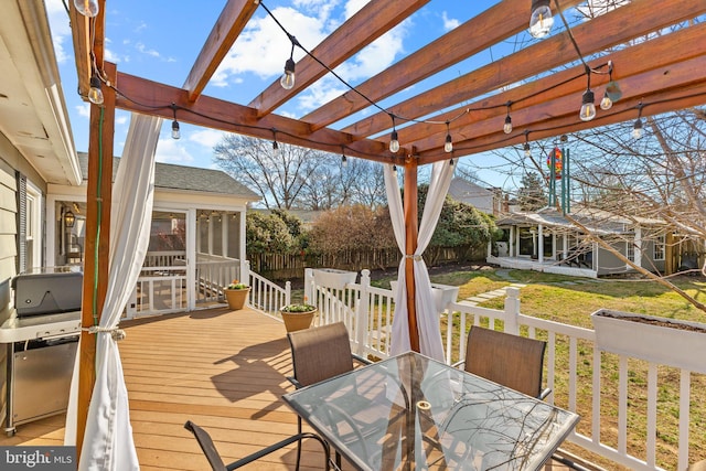 wooden terrace featuring outdoor dining space, an outdoor structure, fence, and a pergola