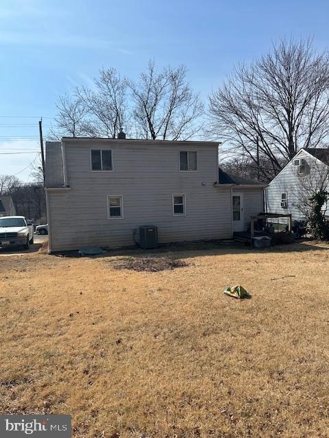 view of side of home with a yard