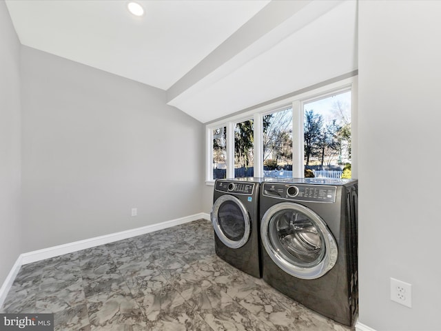 laundry area featuring baseboards, marble finish floor, laundry area, and washer and clothes dryer