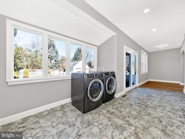 clothes washing area with recessed lighting, independent washer and dryer, and baseboards