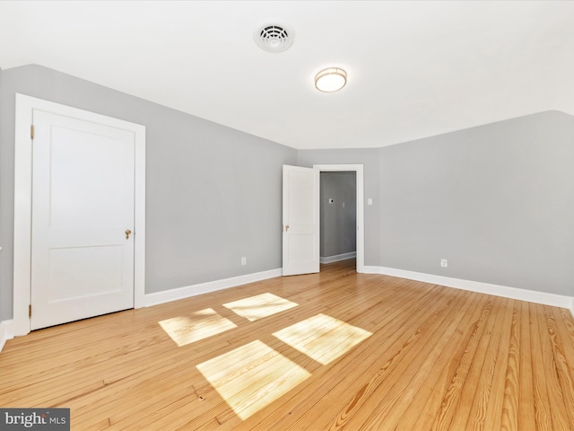 interior space featuring visible vents, light wood-style flooring, and baseboards