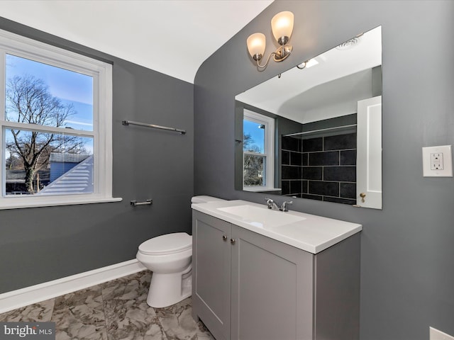 bathroom featuring vanity, baseboards, a shower, toilet, and marble finish floor