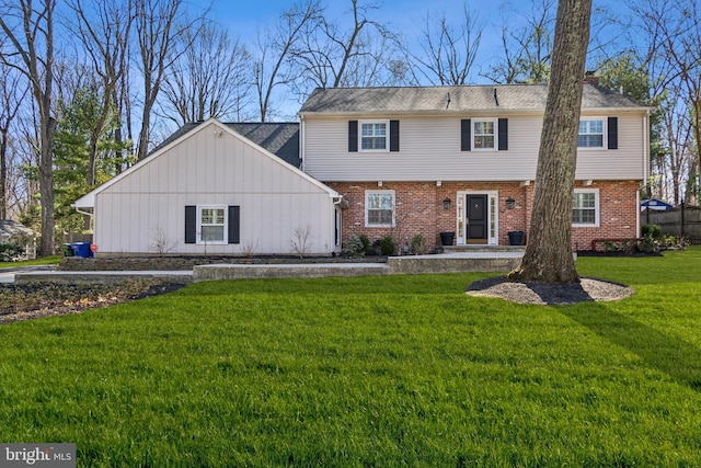 rear view of house with a yard and brick siding