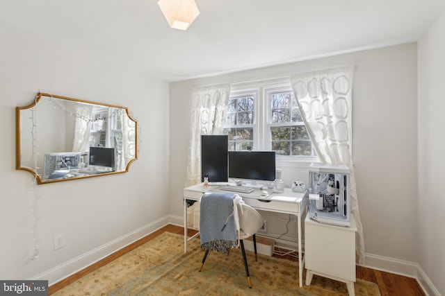 office space with wood finished floors and baseboards