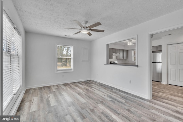 unfurnished living room featuring ceiling fan, baseboards, and wood finished floors