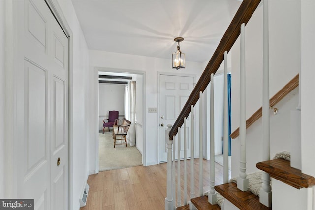 foyer featuring stairway and light wood-style floors