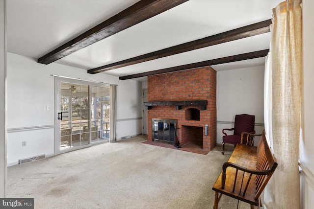 carpeted living room with beam ceiling, a fireplace, visible vents, and baseboards