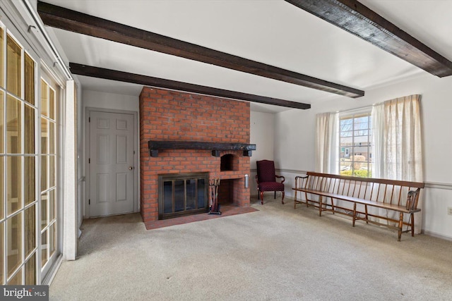 living room featuring baseboards, beam ceiling, a fireplace, and carpet flooring