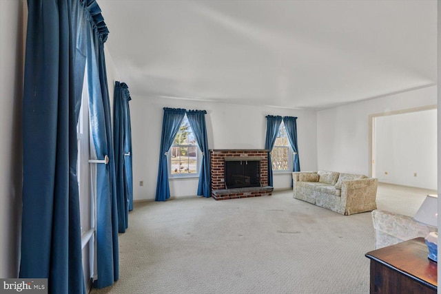 carpeted living room with a brick fireplace