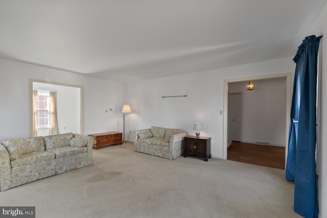 unfurnished living room featuring carpet and visible vents