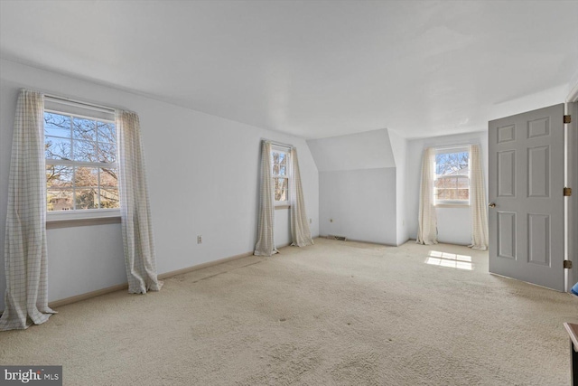 bonus room featuring baseboards, carpet, and vaulted ceiling