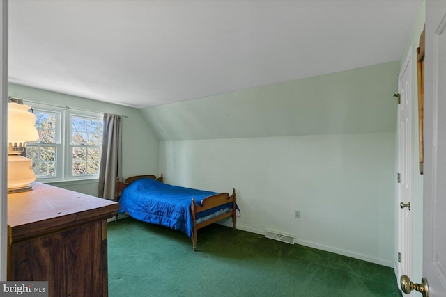 bedroom featuring visible vents, dark carpet, baseboards, and vaulted ceiling