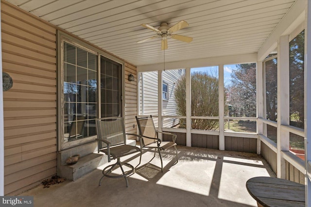 unfurnished sunroom with a ceiling fan