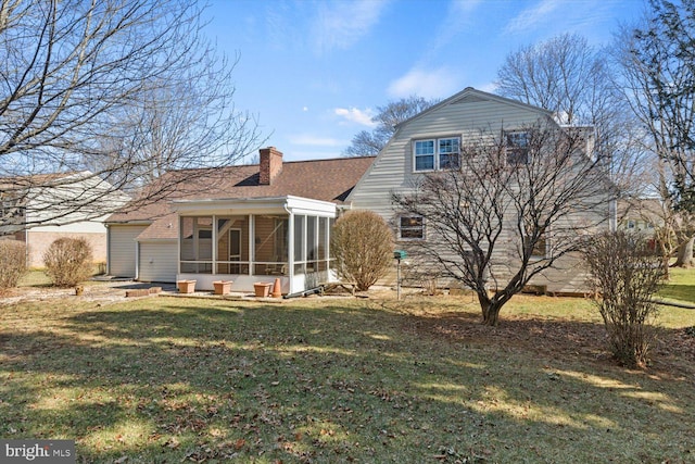 back of property featuring a shingled roof, a gambrel roof, a chimney, a yard, and a sunroom