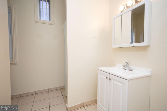 bathroom featuring tile patterned flooring, vanity, and baseboards