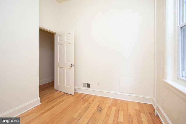 spare room with visible vents, light wood-style flooring, and baseboards