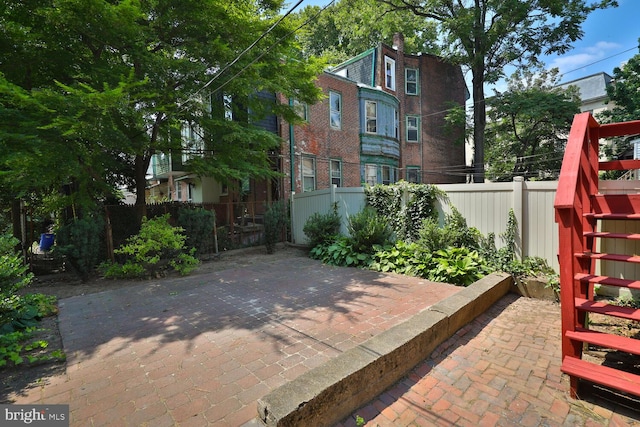 view of patio / terrace with stairway and fence private yard