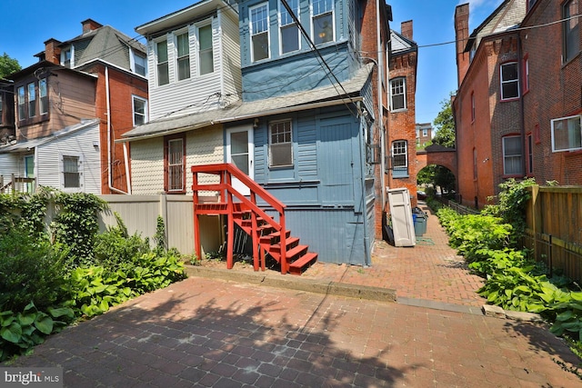 rear view of house with fence