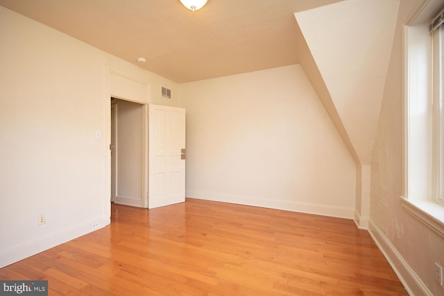 bonus room with visible vents, baseboards, and light wood-style floors