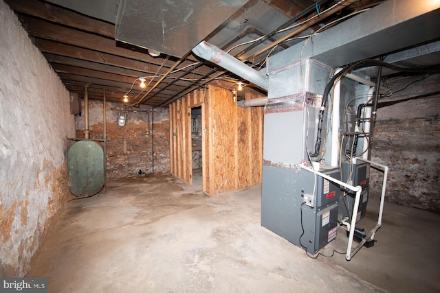 unfinished below grade area featuring heating unit and heating fuel