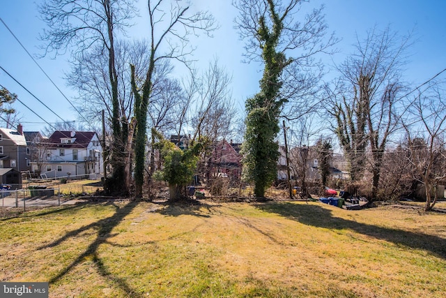 view of yard featuring a residential view and fence