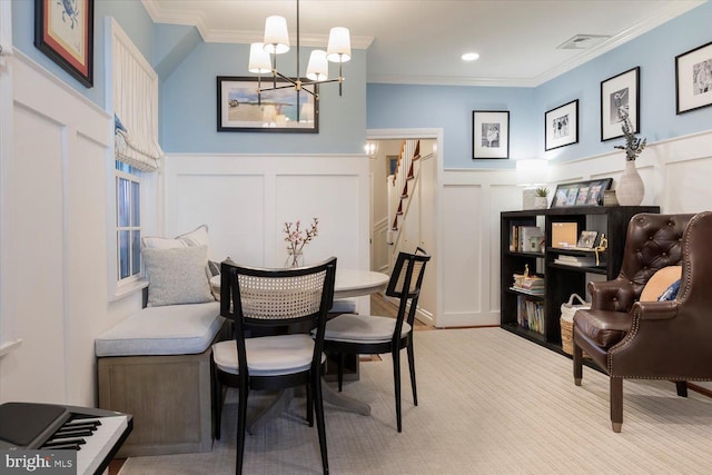 dining area featuring visible vents, a notable chandelier, ornamental molding, a decorative wall, and stairs