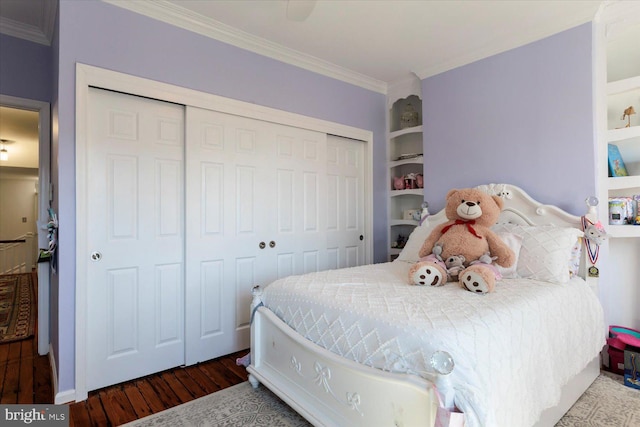 bedroom featuring a closet, wood finished floors, and ornamental molding