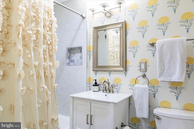 bathroom featuring vanity, toilet, and shower / bath combo with shower curtain