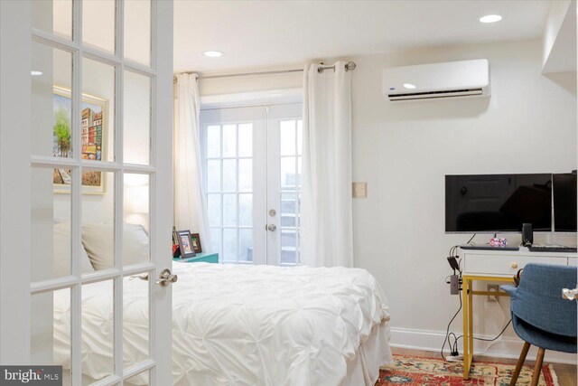 bedroom with baseboards, a wall mounted AC, recessed lighting, french doors, and access to outside