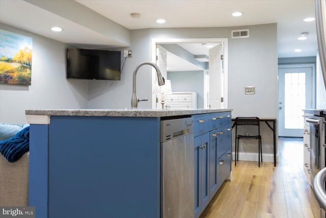 kitchen featuring blue cabinetry, visible vents, light wood-style flooring, and recessed lighting
