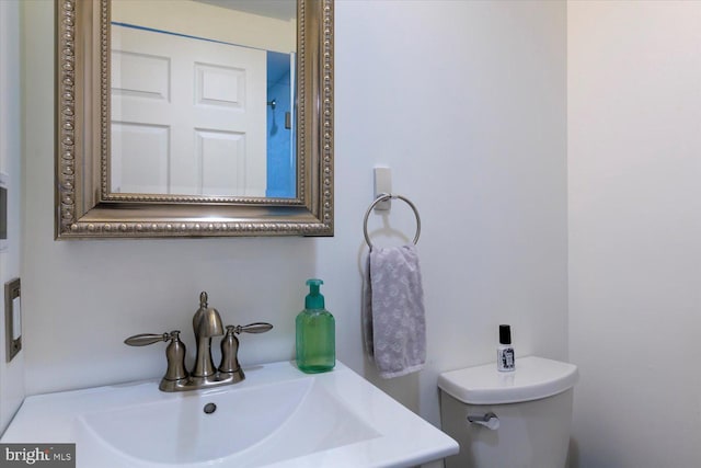 half bath featuring toilet and a sink