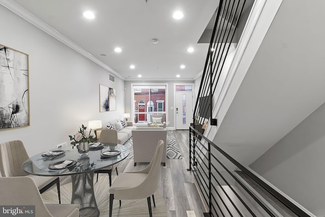 dining space with stairway, wood finished floors, visible vents, recessed lighting, and ornamental molding