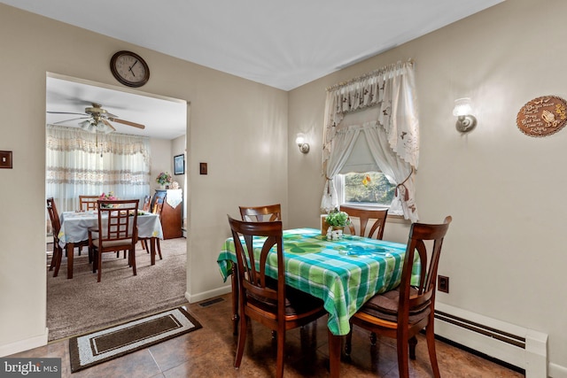 carpeted dining space featuring a ceiling fan, baseboards, visible vents, a baseboard radiator, and tile patterned floors