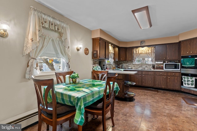 dining space with a baseboard radiator