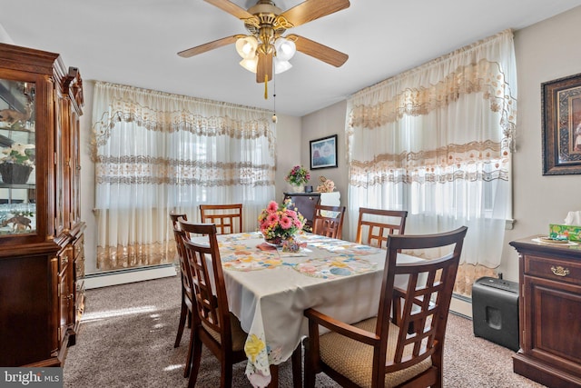 dining room featuring a baseboard heating unit, plenty of natural light, carpet, and a ceiling fan