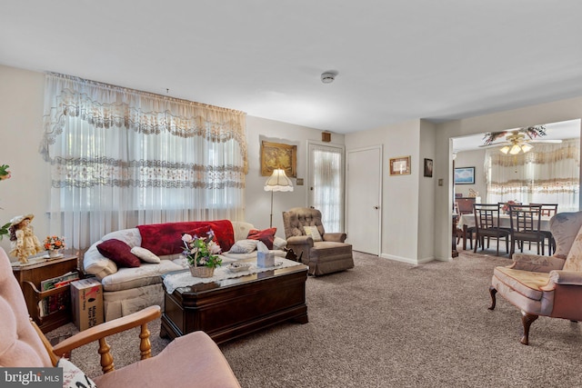 living room with baseboards and carpet