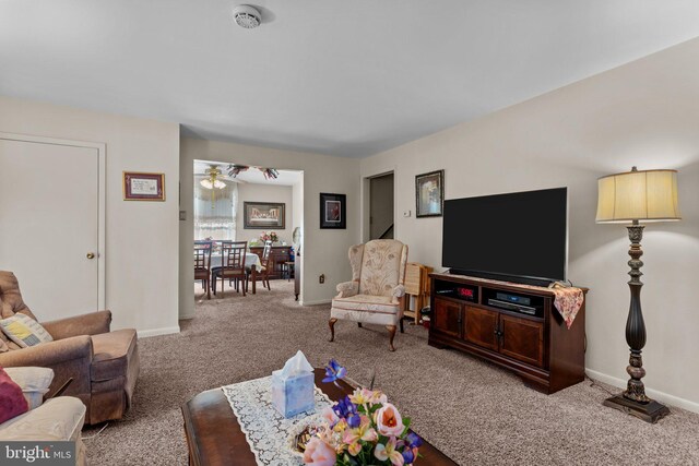 living room featuring baseboards and carpet floors