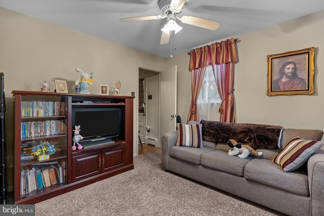 carpeted living room featuring baseboard heating and a ceiling fan