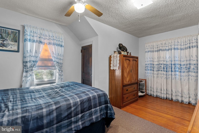 bedroom with light wood-style floors and a textured ceiling