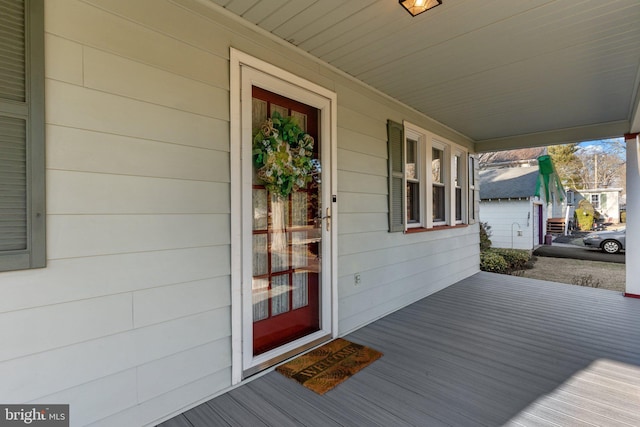 view of exterior entry featuring a porch