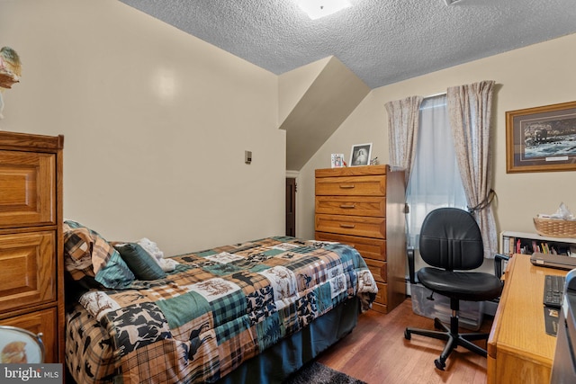 bedroom featuring a textured ceiling and wood finished floors