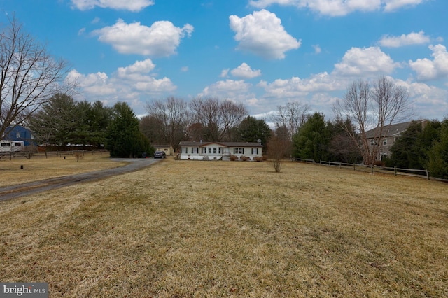 view of yard featuring a rural view and fence