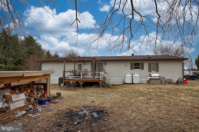 rear view of property featuring a deck