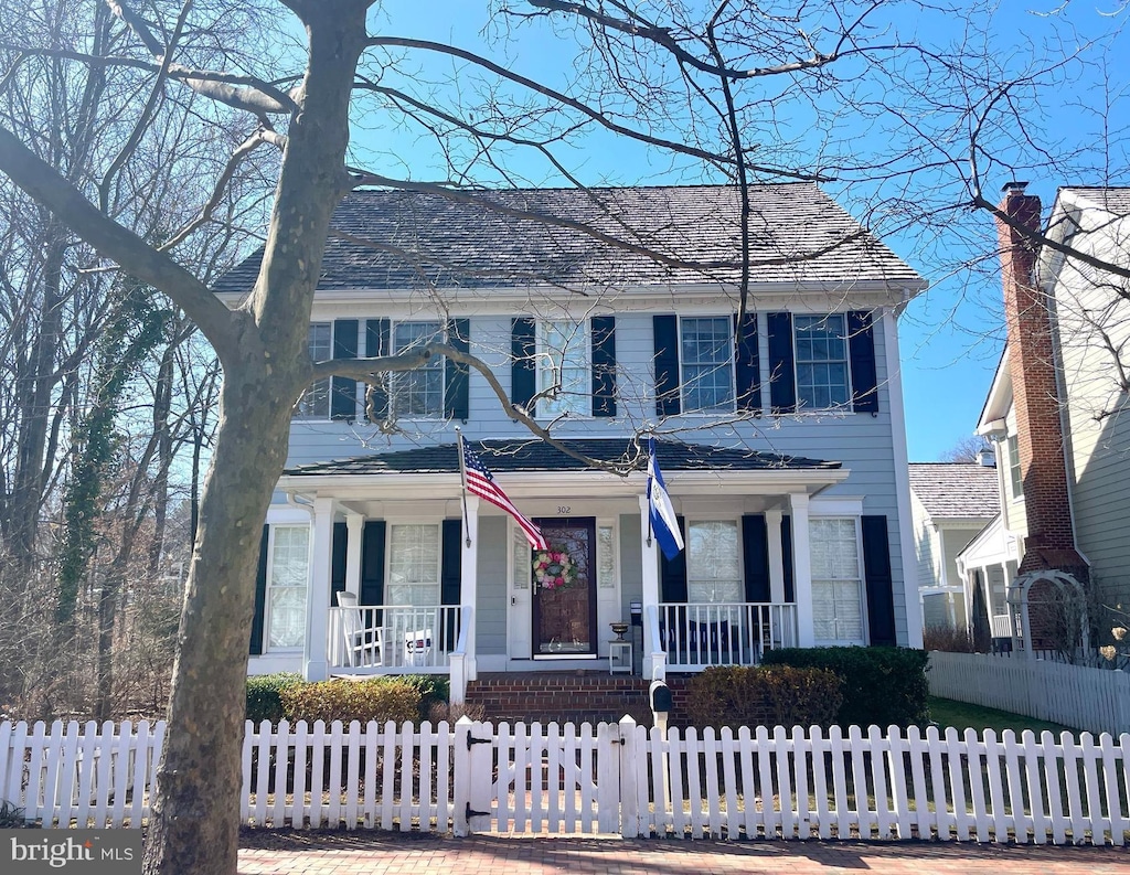 view of front of house featuring a fenced front yard and a porch