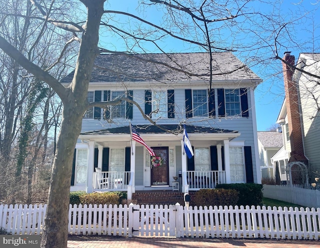 view of front of house featuring a fenced front yard and a porch