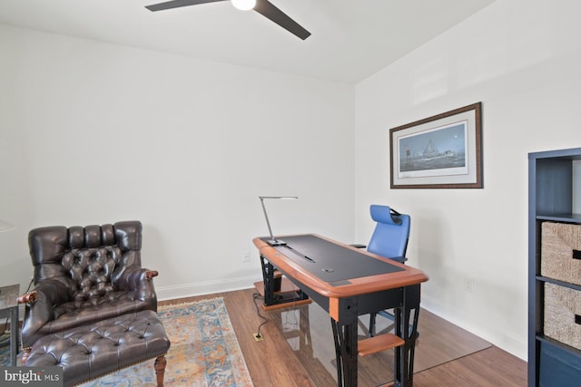 office area featuring ceiling fan, baseboards, and wood finished floors