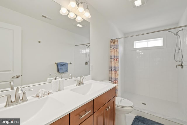 full bath featuring a tile shower, visible vents, toilet, and a sink