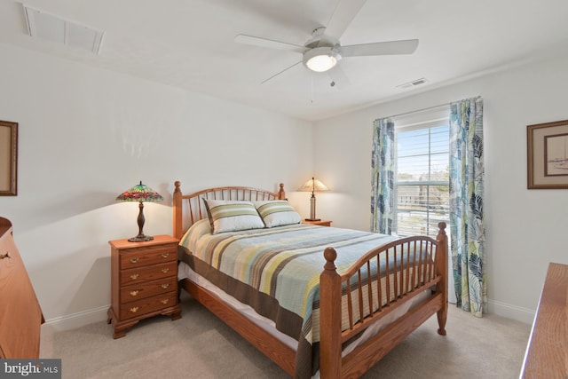 bedroom featuring visible vents, baseboards, light colored carpet, and ceiling fan